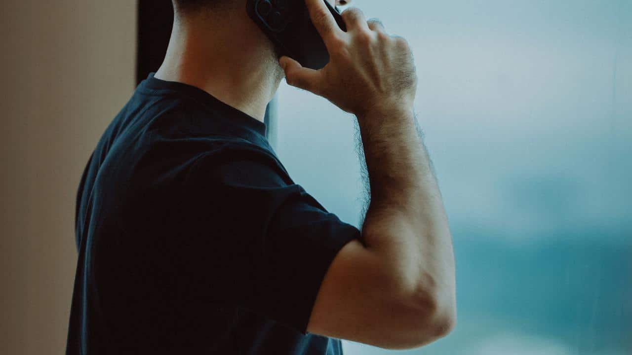 A man holding a phone to his ear