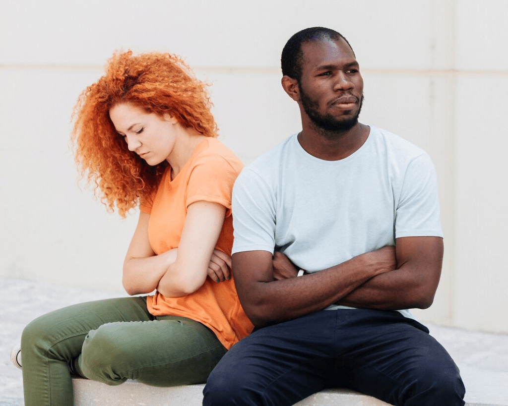 Couple ignoring each other sitting