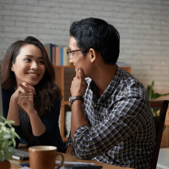 Two people looking at each other in cafe