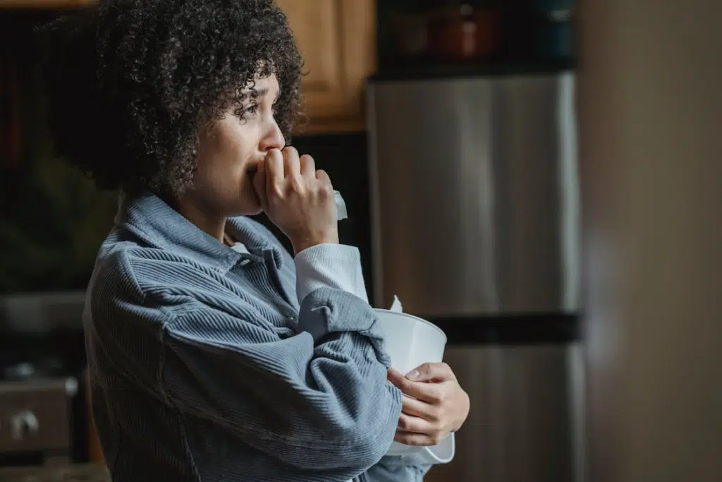 Upset woman crying staring out window