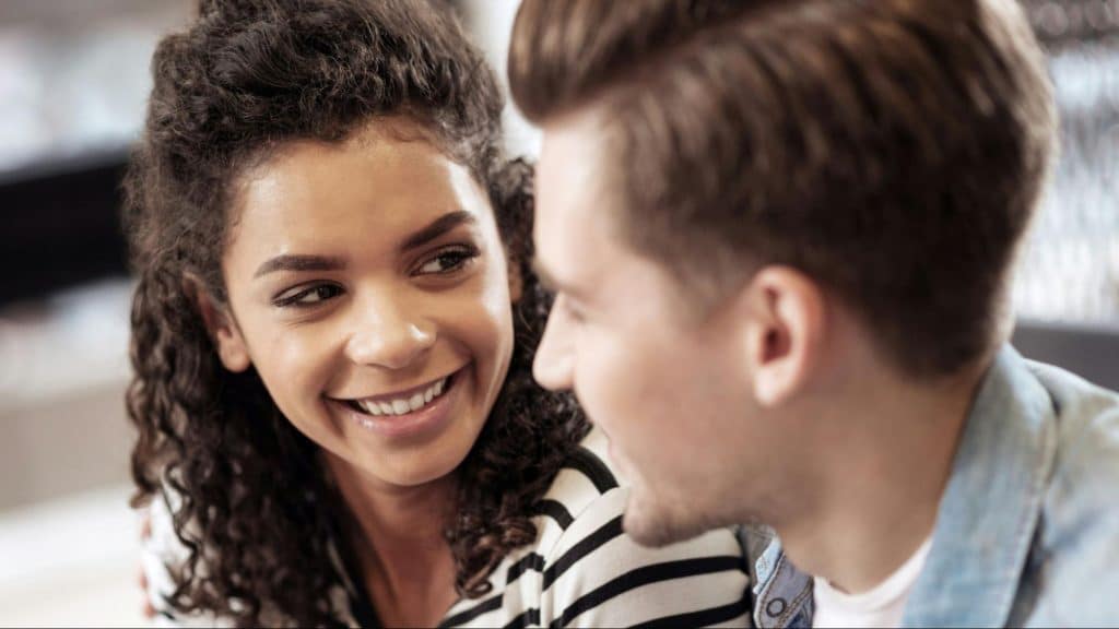 A man and woman smiling at each other