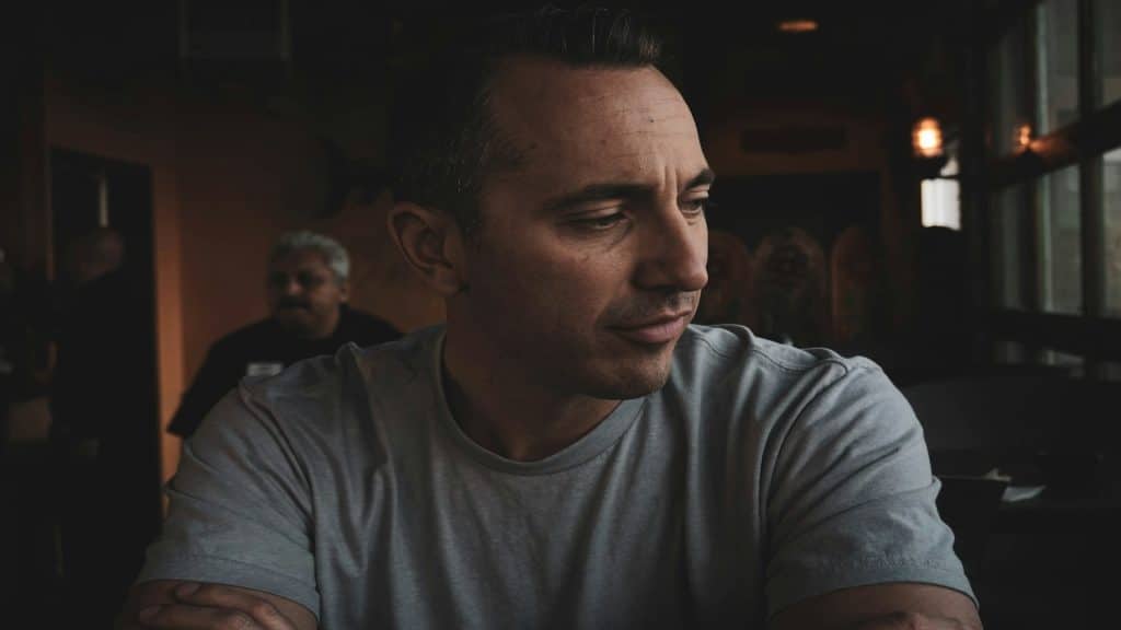man looking thoughtful during conversation