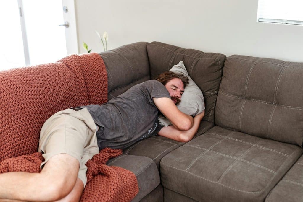 exhausted man sofa