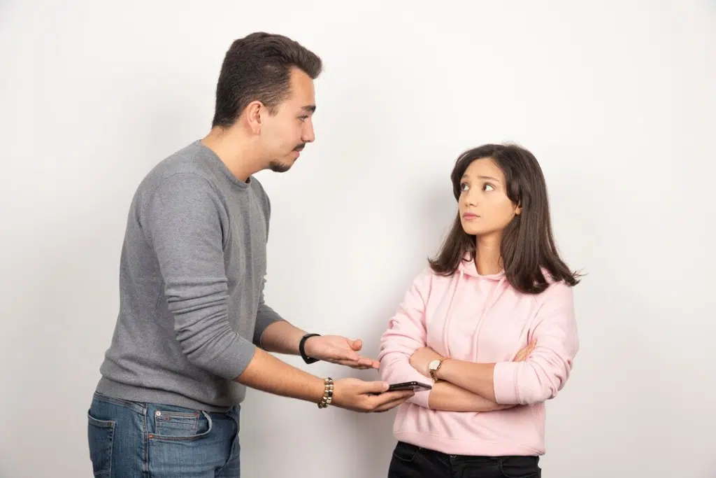 Man softly speaking to annoyed woman