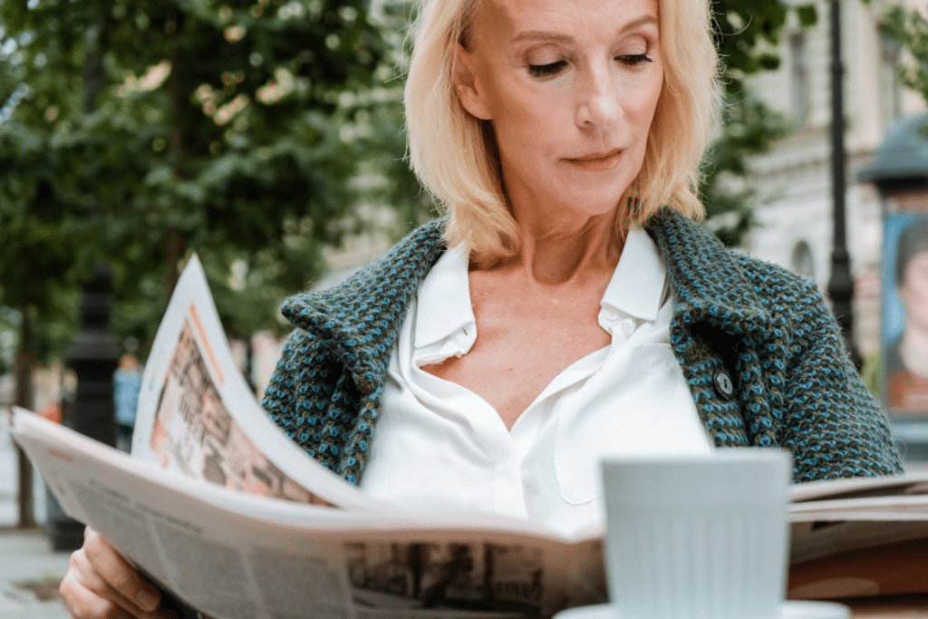 Mature woman enjoying leisure coffee and reading