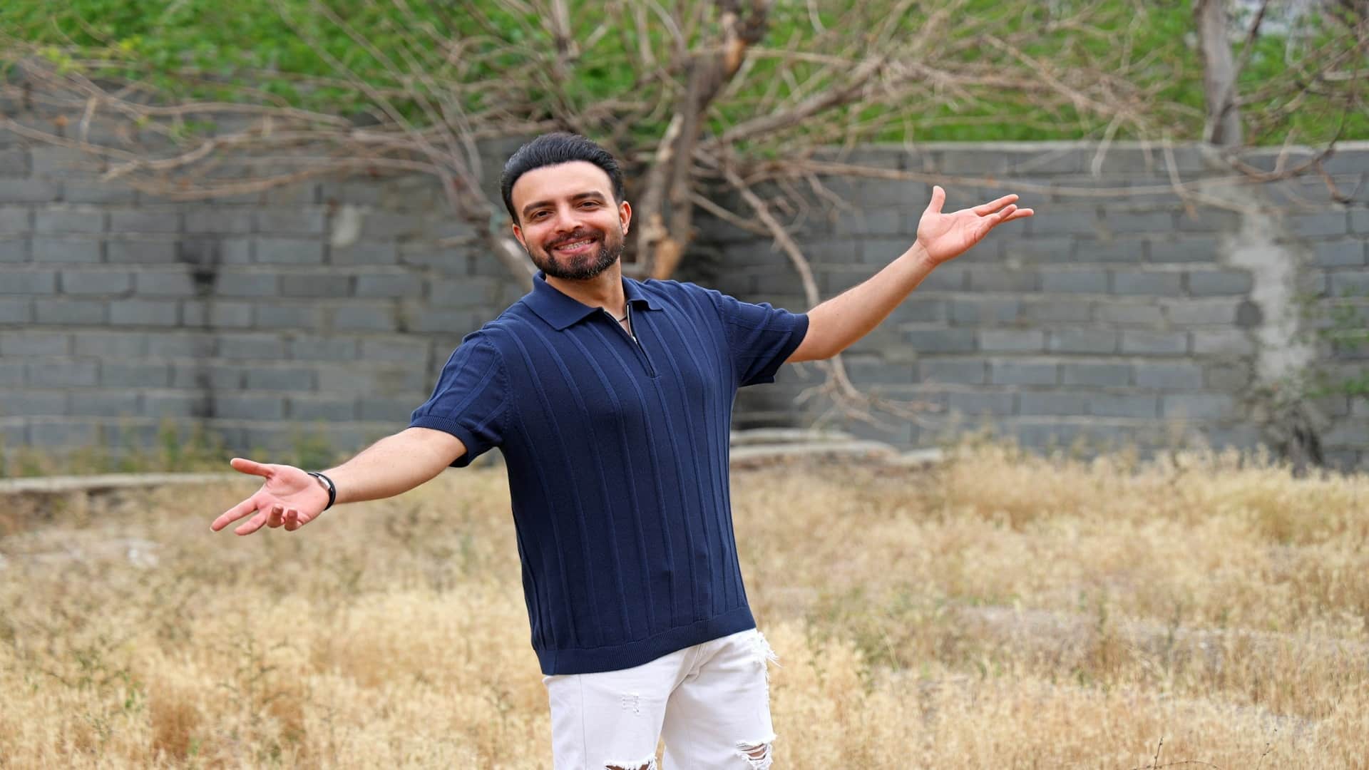 man standing confidently outdoors