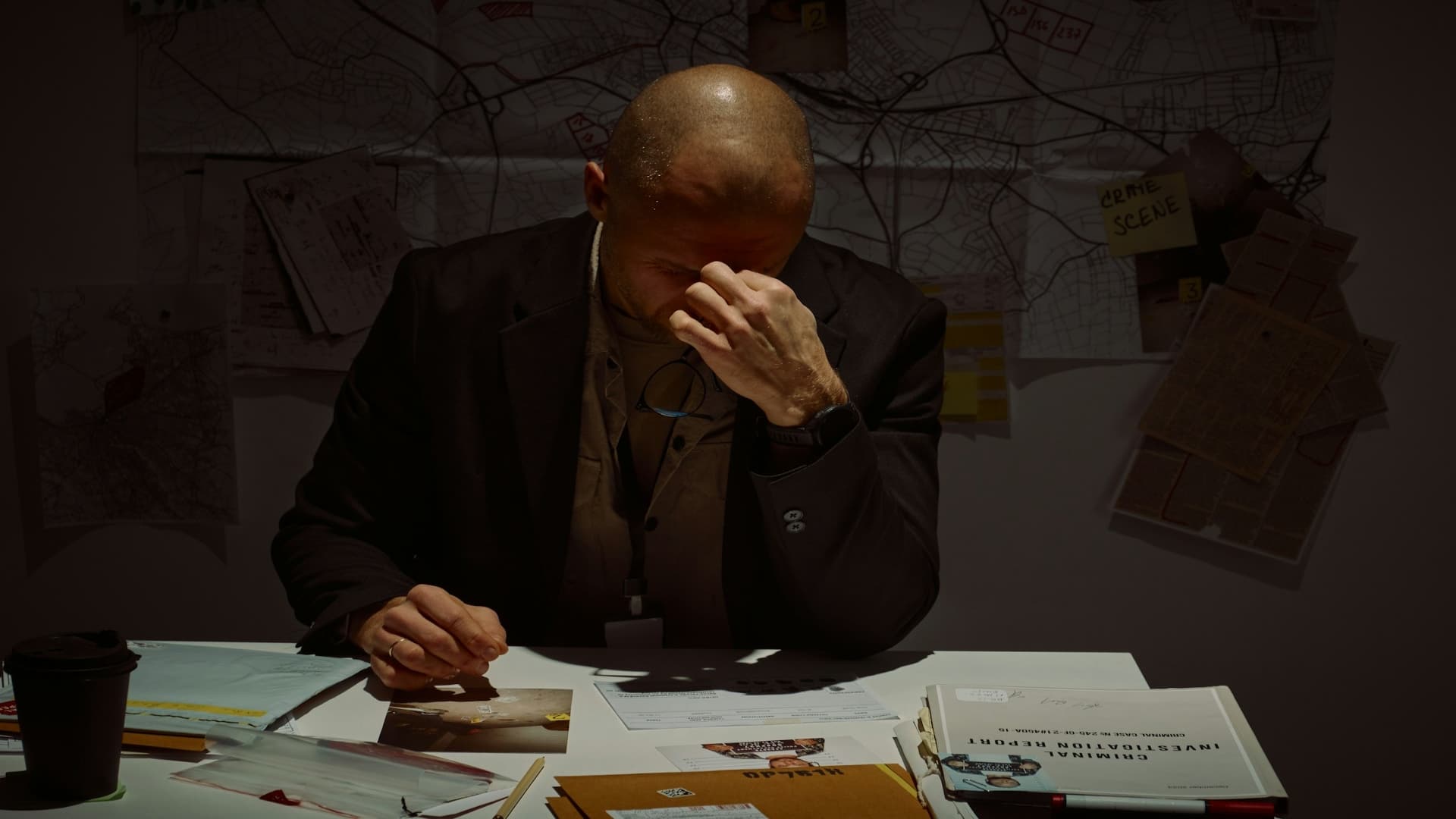 man looking stressed while bills on desk