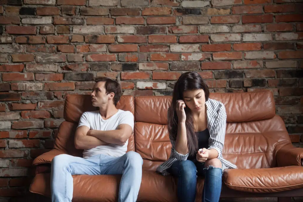 A man and woman together but not talking to each other