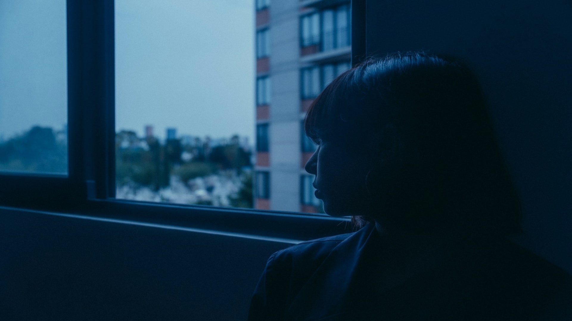 individual reflecting near window