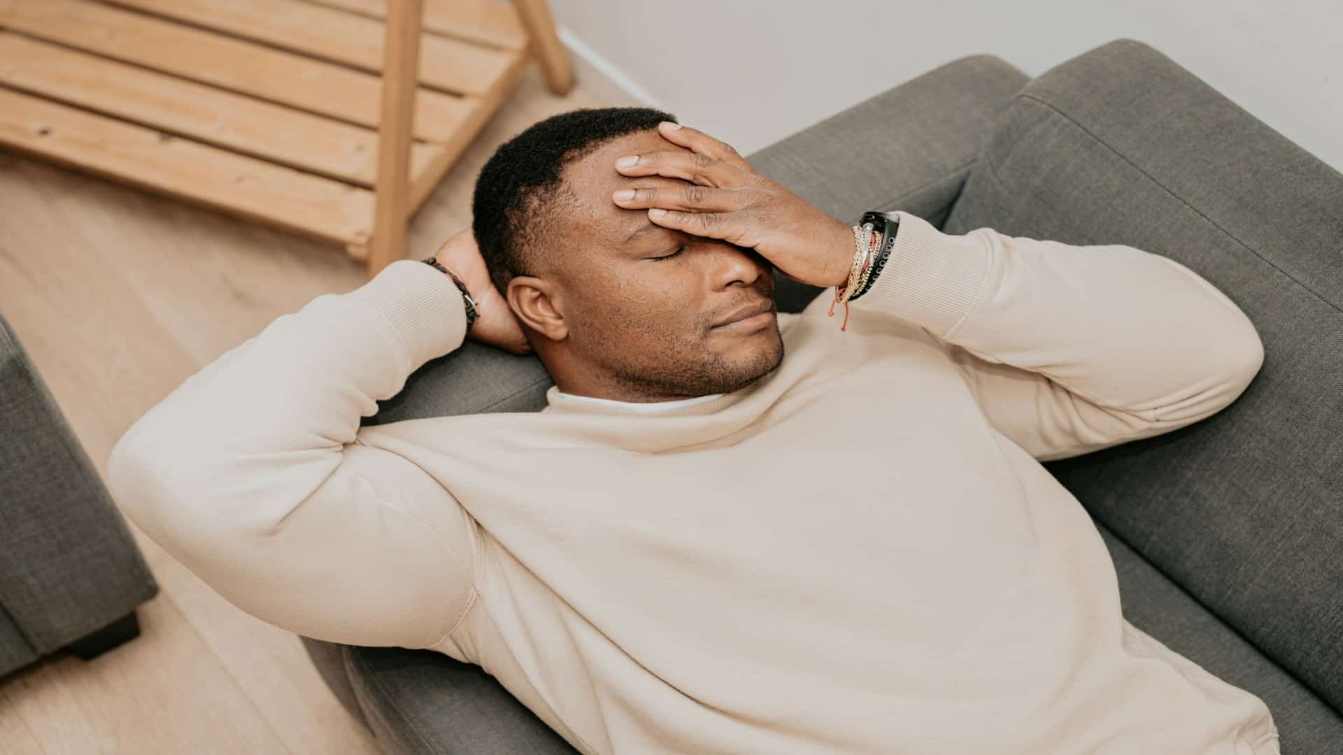 man resting head on hand