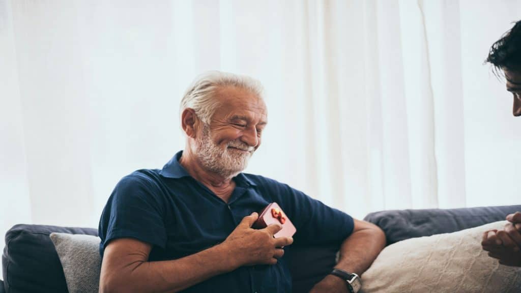 man relaxing and smiling during conversation