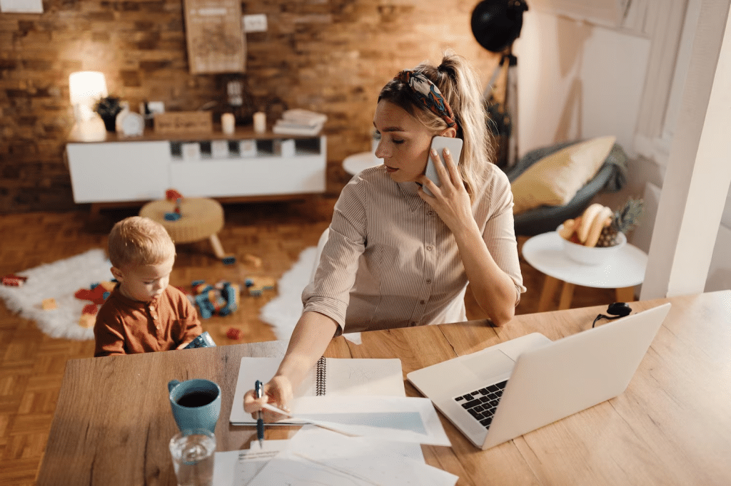 Woman taking care of a child while working 