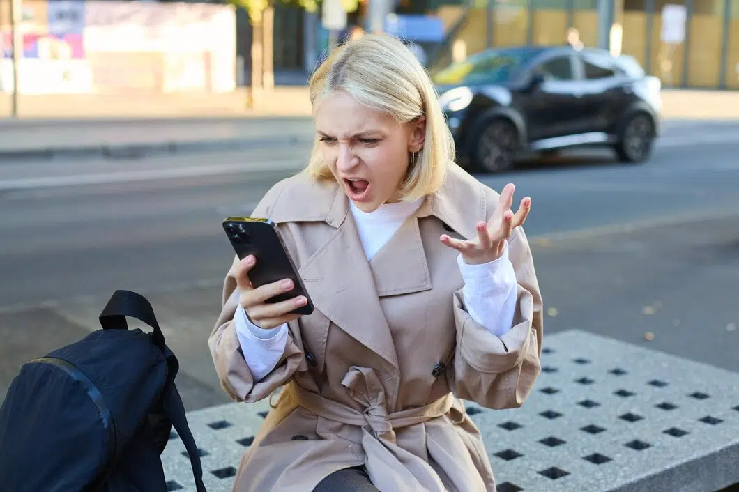 Angry woman shouting at phone