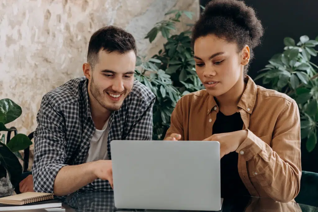 A Man and Woman Using a Laptop Together