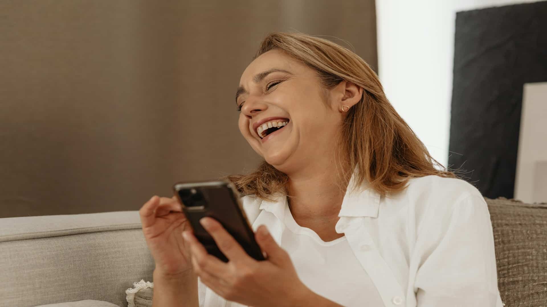 woman smiling while texting