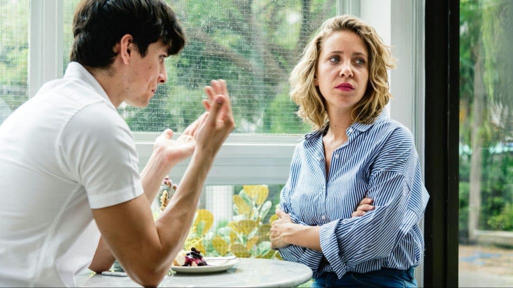 A man being defensive to woman