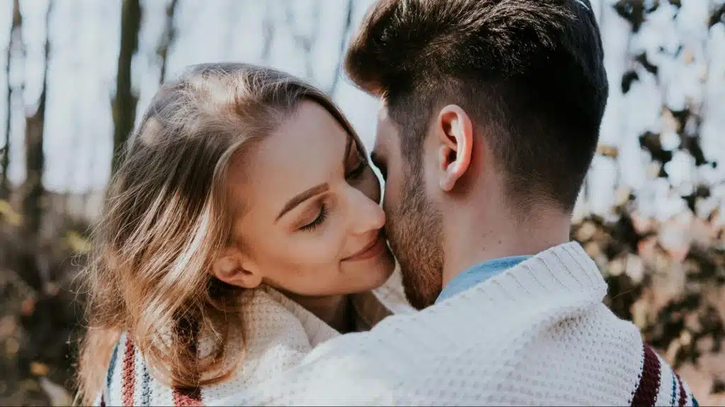 A woman kissing man’s face