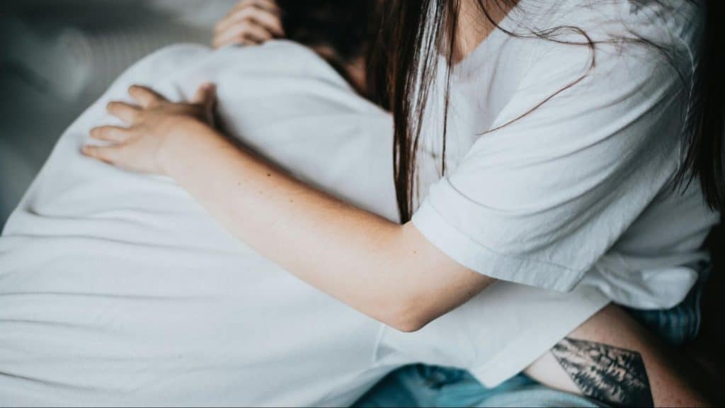 A man hugging a woman