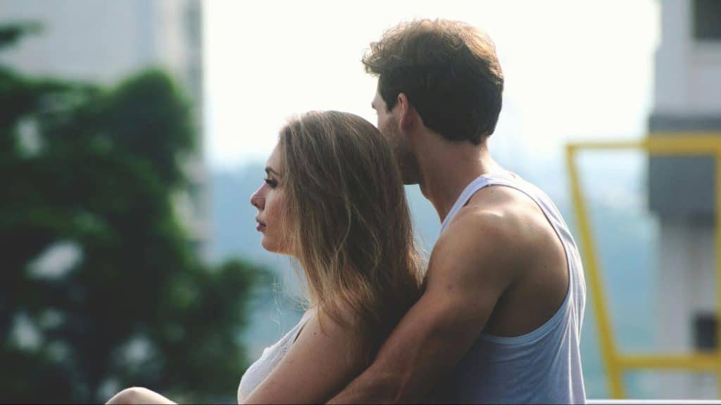 A man hugging woman