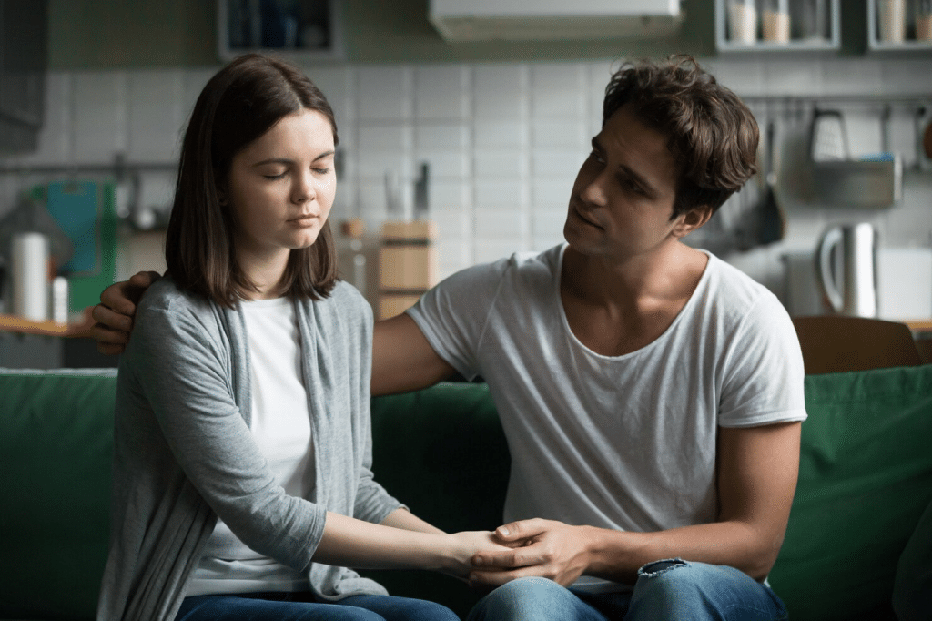 A man apologizing to woman 
