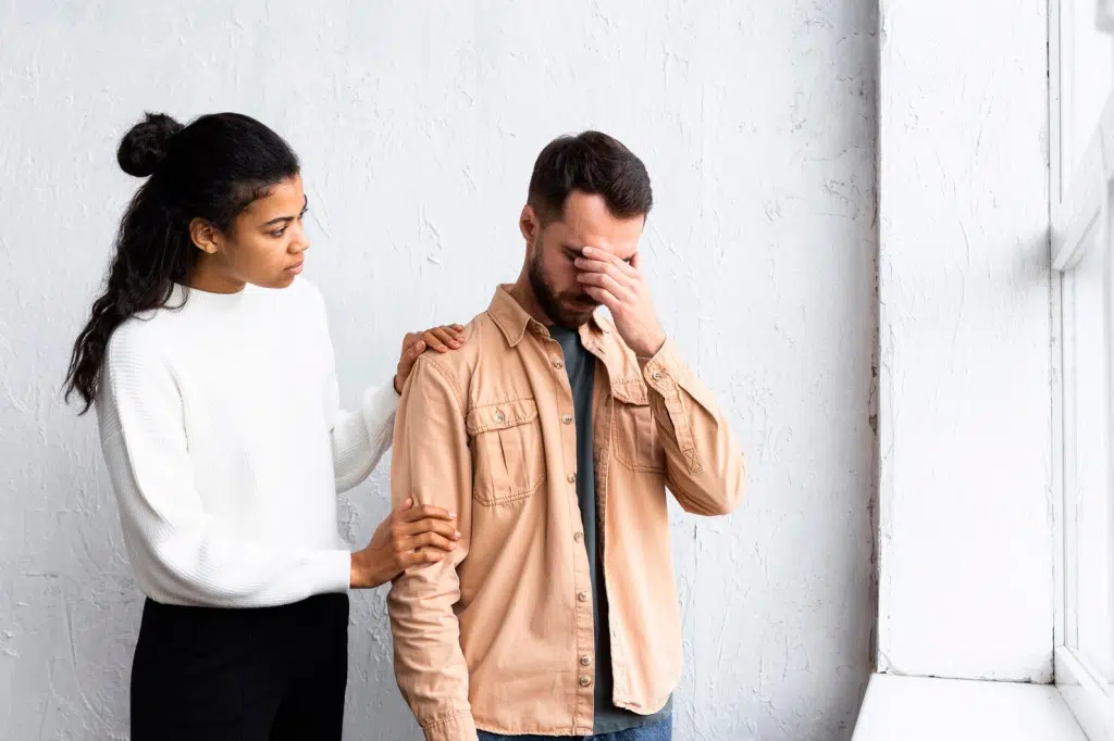 A man covering his face