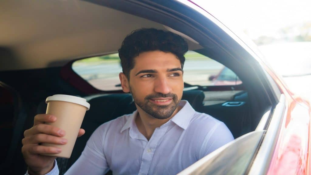 man bringing coffee to partner