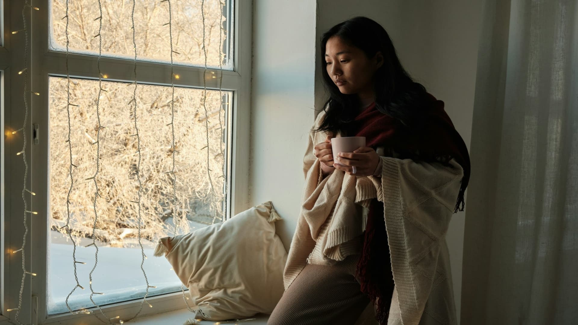 individual thinking quietly indoors