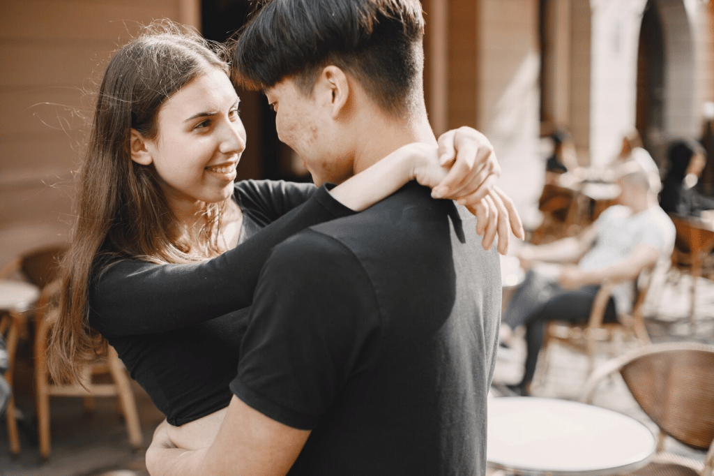 A man hugging a woman 