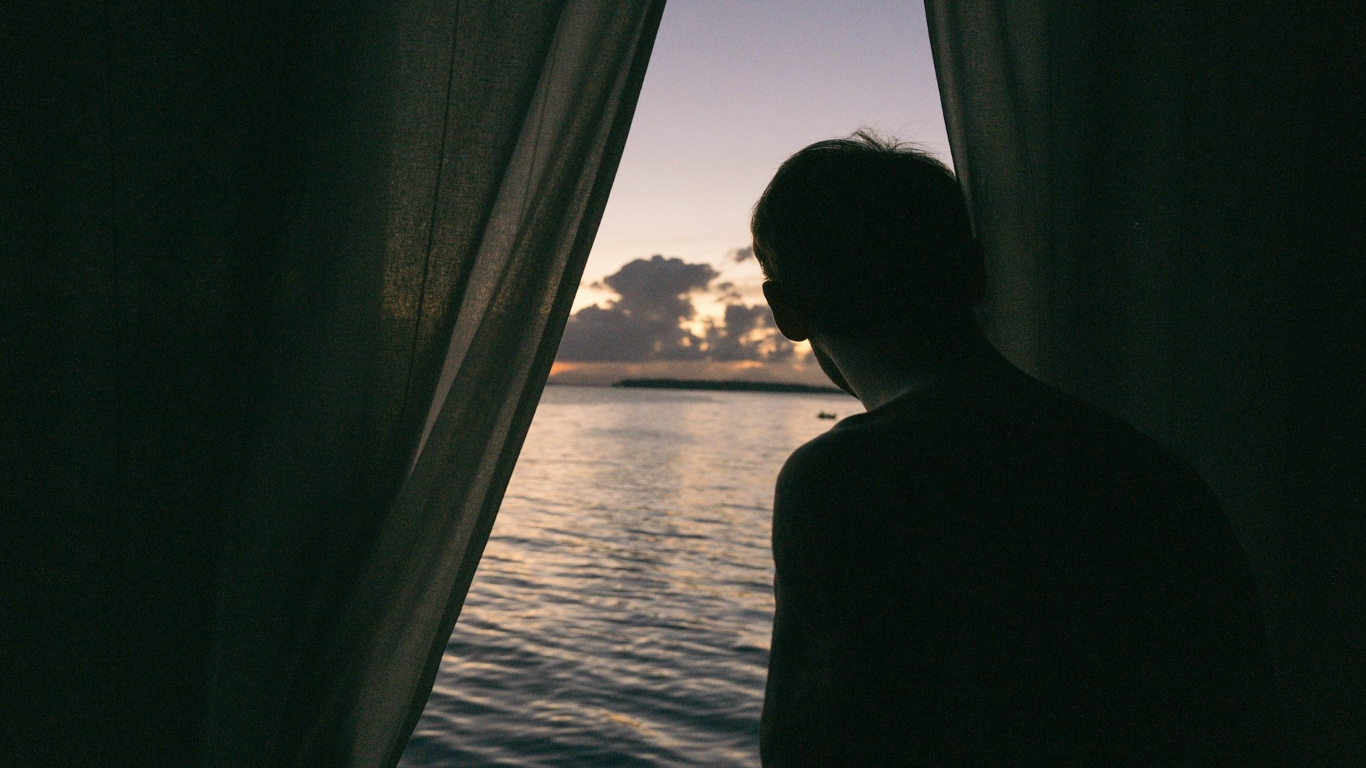 man reflecting quietly by window