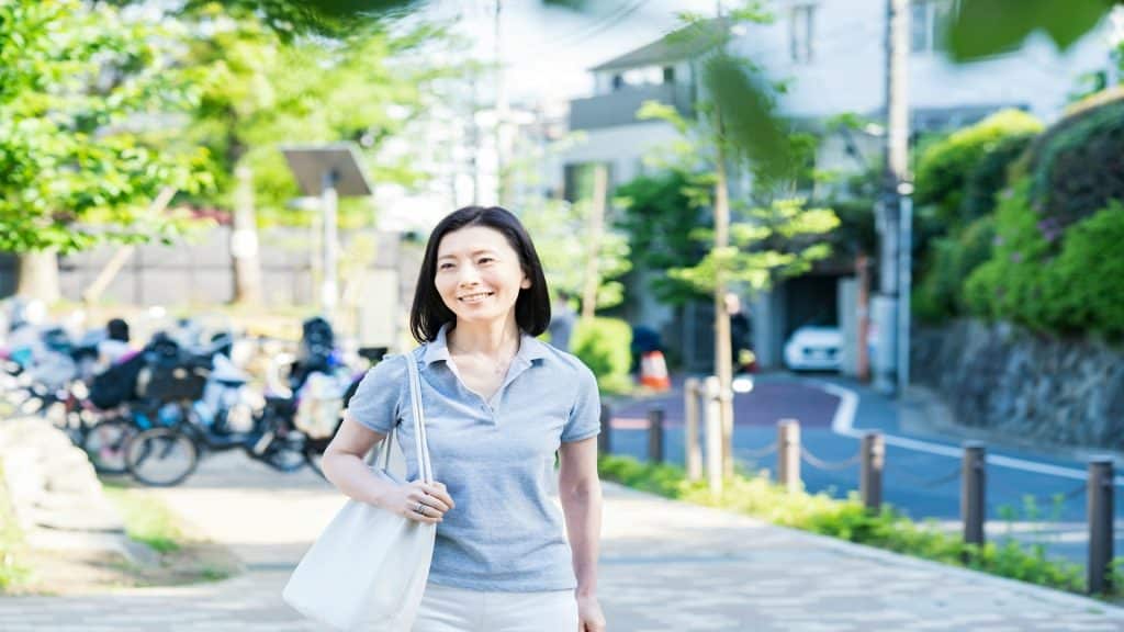 woman smiling while walking outdoors