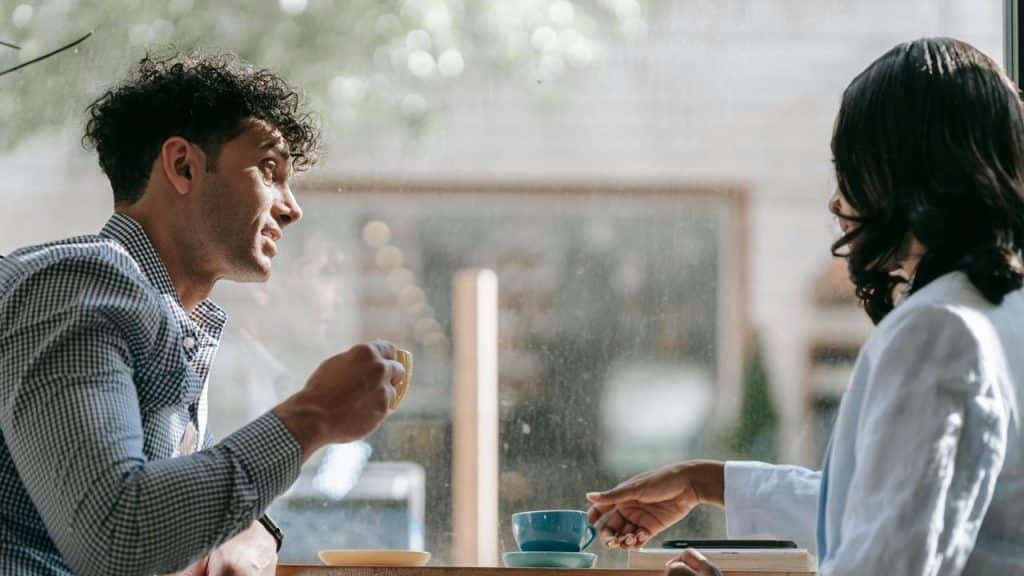A man and woman talking while having coffee
