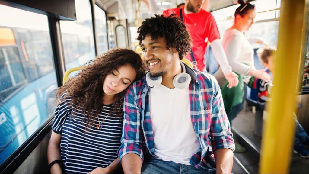 A man laughing and a woman feels sad