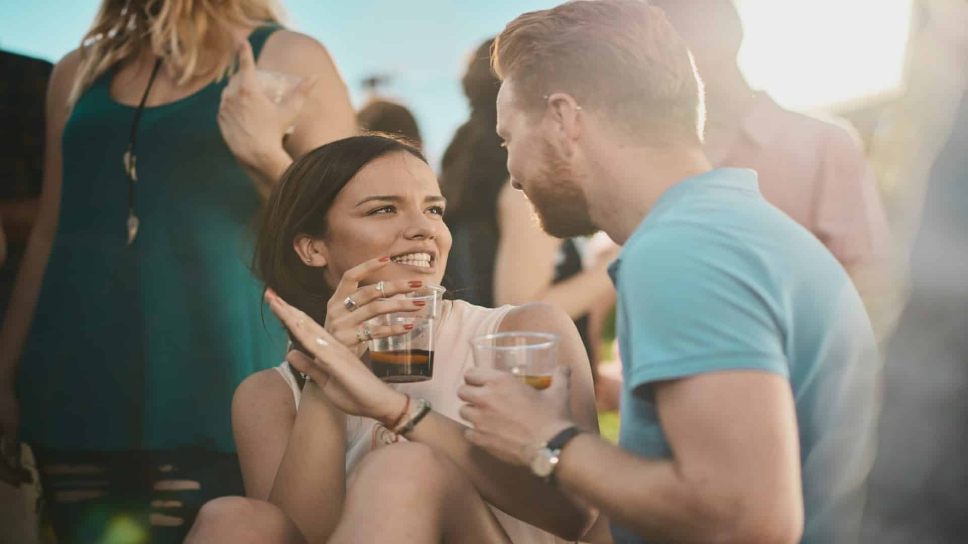 man introducing partner at social gathering