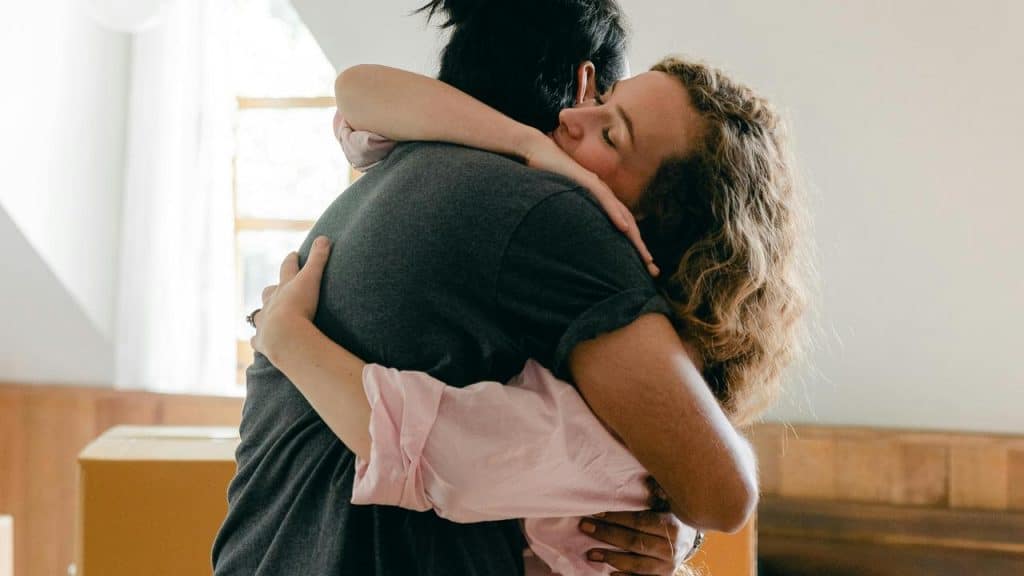 A couple hugging closely indoors.