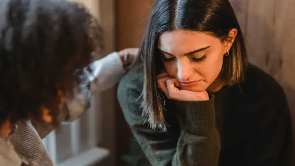 A sad woman being comforted