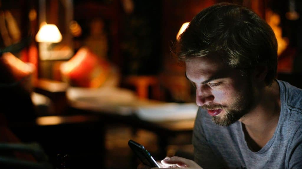 A man texting someone late at night