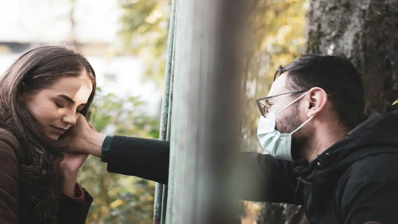A man touching his wife’s face