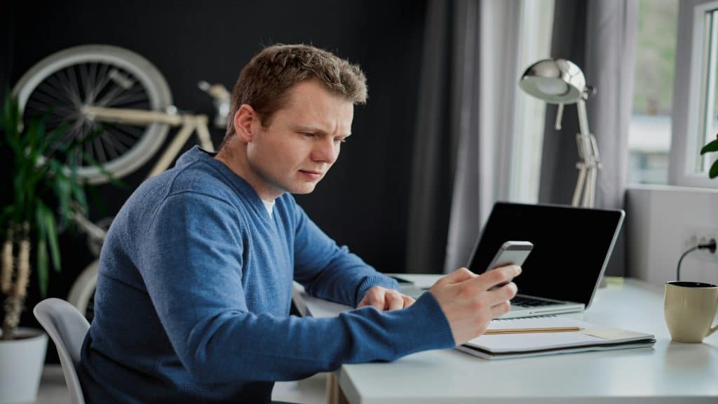 man texting and then putting phone down
