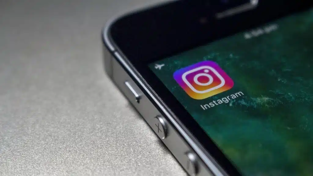 A close-up of a smartphone screen displaying the Instagram app icon and the phone's volume buttons.