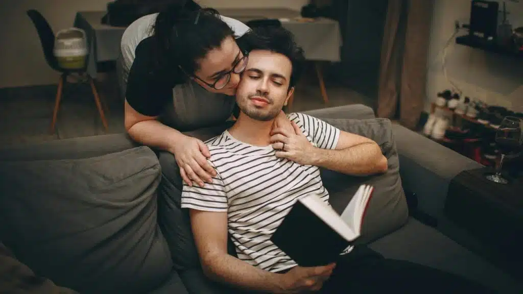 A woman kissing a man on the cheek
