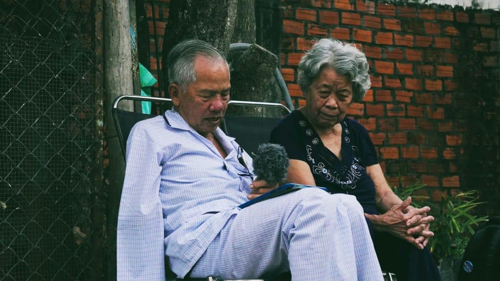 couple sitting close but serious