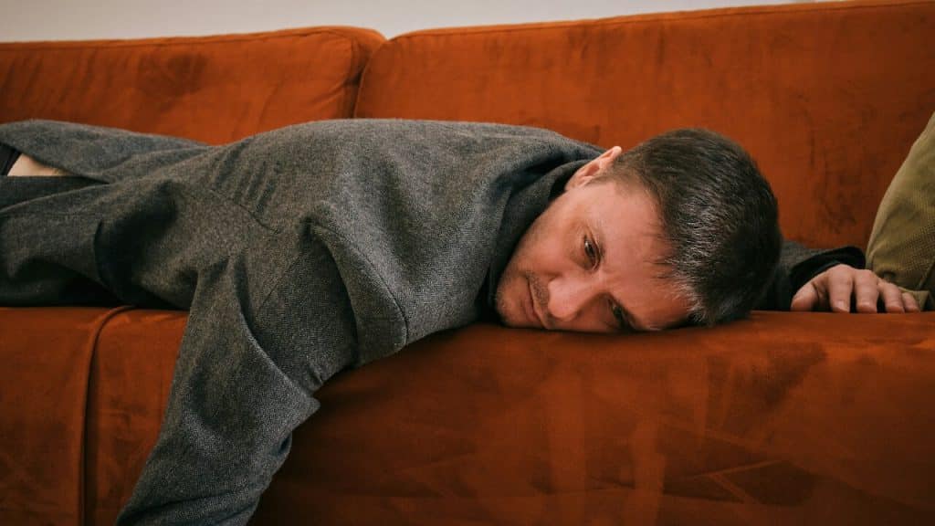 A man laying on a couch