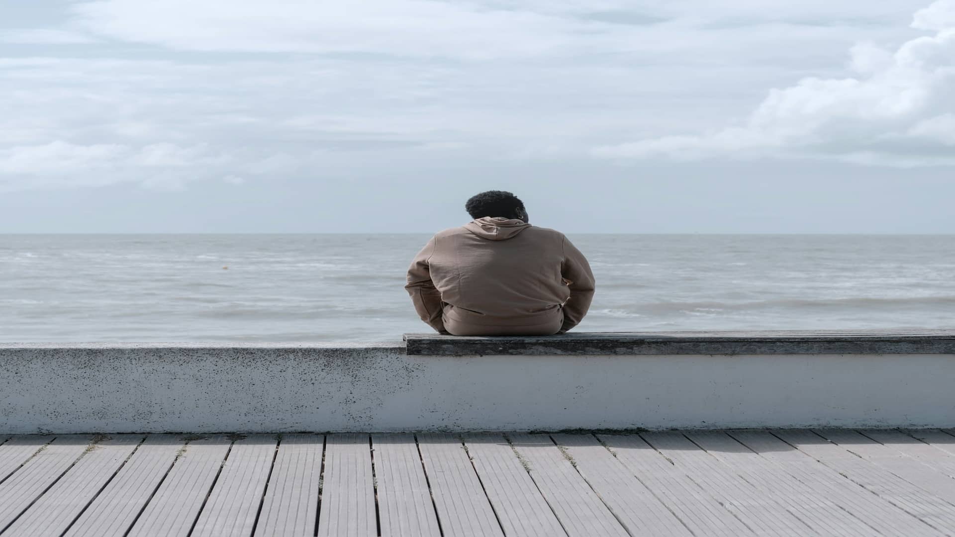 man sitting quietly looking distant