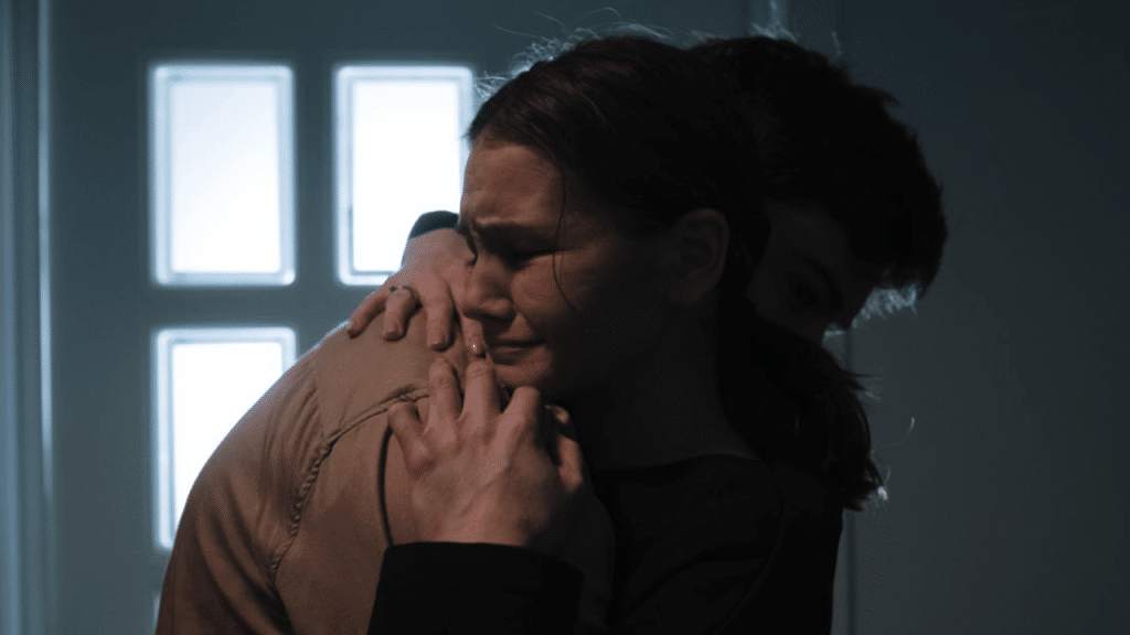 A man comforting his crying wife