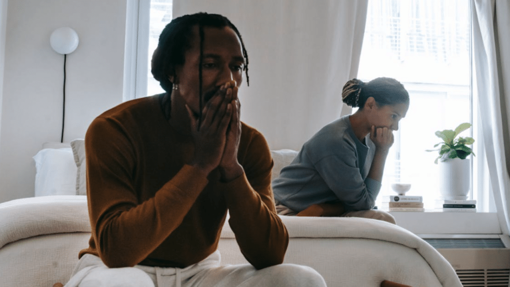 A couple looking sad in the bedroom