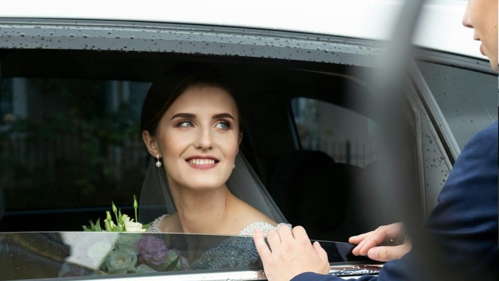 A man opening car door for his wife.