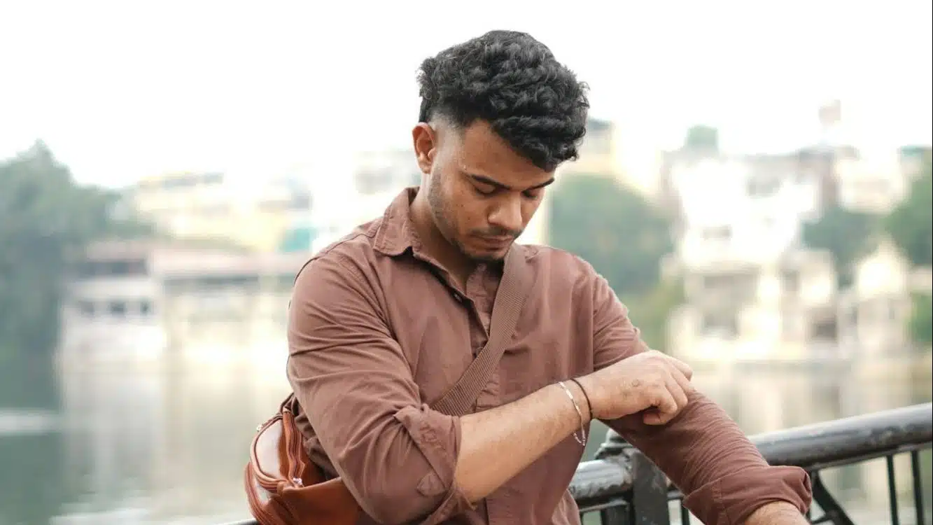 man adjusting jacket