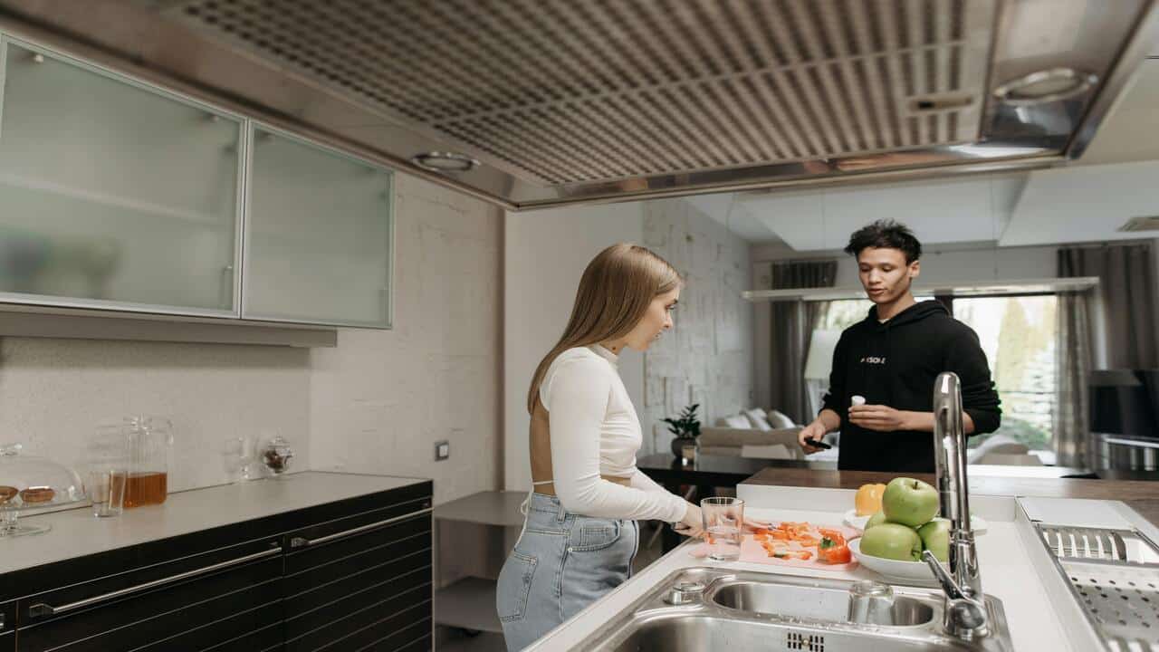 A couple busy int he kitchen