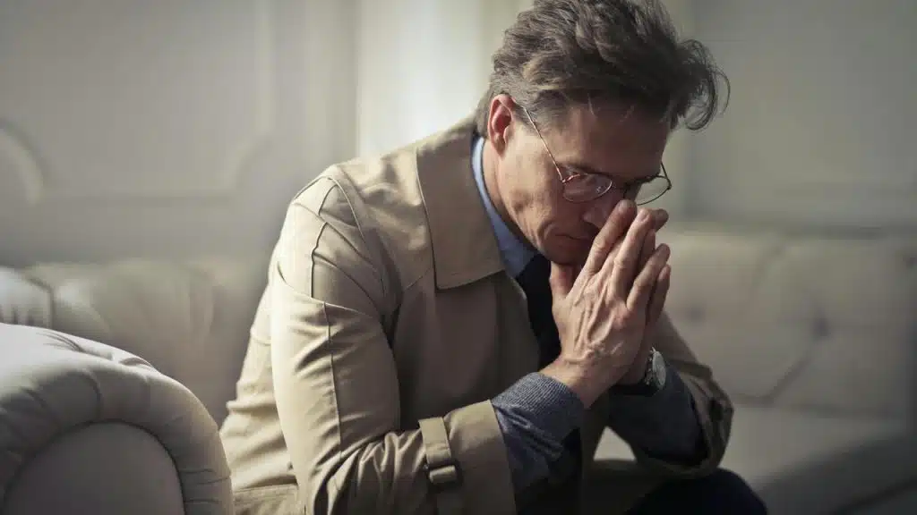 A man sitting with hands clasped