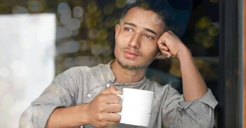 thoughtful man by window